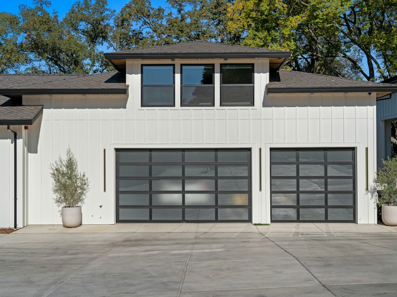 Modern garage doors on a white house